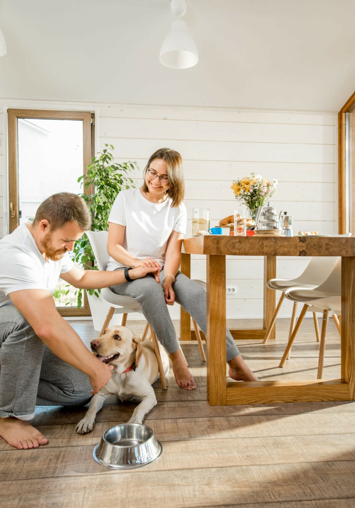 Young couple with dog at home | The Kitchen, Bathroom & Flooring Store